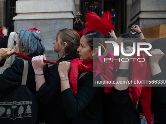 Members of the Cueca Sola collective perform an activity in front of the Palacio de La Moneda to commemorate the 51st anniversary of the Mil...