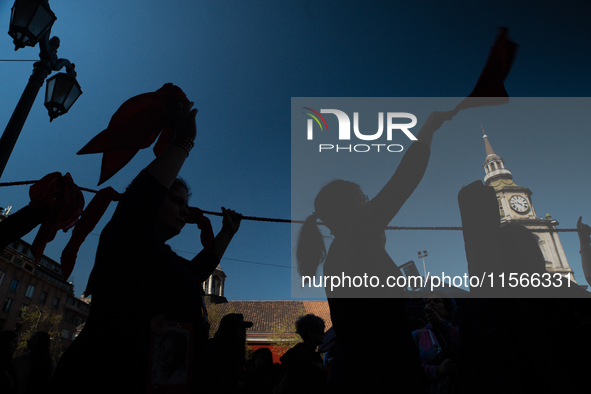 Members of the Cueca Sola collective perform an activity in front of the Palacio de La Moneda to commemorate the 51st anniversary of the Mil...