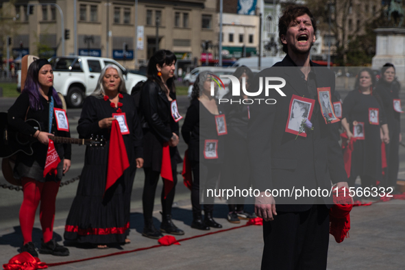 Members of the Cueca Sola collective perform an activity in front of the Palacio de La Moneda to commemorate the 51st anniversary of the Mil...