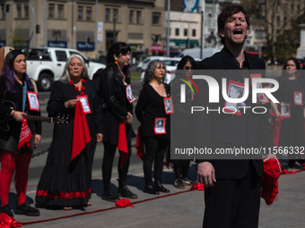 Members of the Cueca Sola collective perform an activity in front of the Palacio de La Moneda to commemorate the 51st anniversary of the Mil...