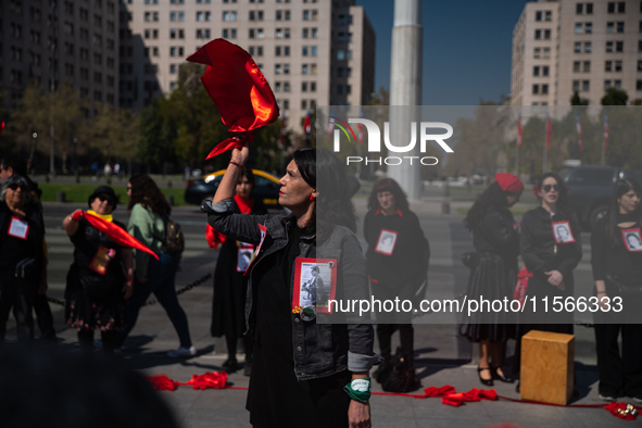 Members of the Cueca Sola collective perform an activity in front of the Palacio de La Moneda to commemorate the 51st anniversary of the Mil...