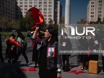 Members of the Cueca Sola collective perform an activity in front of the Palacio de La Moneda to commemorate the 51st anniversary of the Mil...