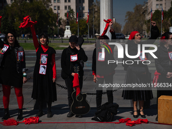 Members of the Cueca Sola collective perform an activity in front of the Palacio de La Moneda to commemorate the 51st anniversary of the Mil...