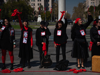 Members of the Cueca Sola collective perform an activity in front of the Palacio de La Moneda to commemorate the 51st anniversary of the Mil...