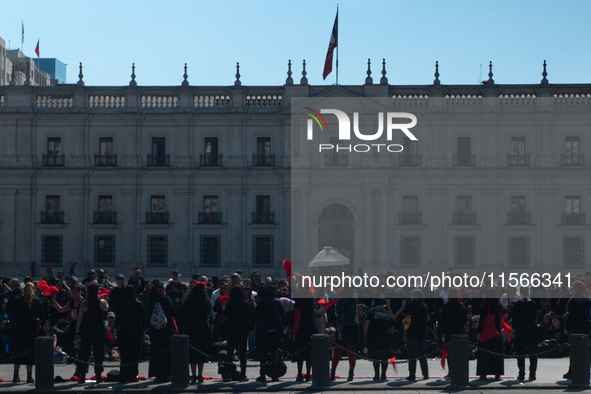 Members of the Cueca Sola collective perform an activity in front of the Palacio de La Moneda to commemorate the 51st anniversary of the Mil...