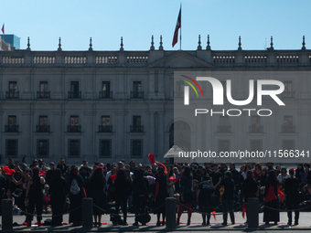 Members of the Cueca Sola collective perform an activity in front of the Palacio de La Moneda to commemorate the 51st anniversary of the Mil...