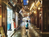 Tourists view the area amid heavy rain affected by a typhoon in Shanghai, China, on September 10, 2024. (