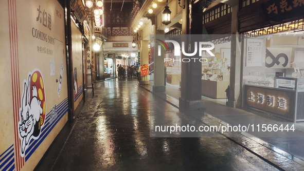 Tourists view the area amid heavy rain affected by a typhoon in Shanghai, China, on September 10, 2024. 