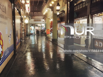 Tourists view the area amid heavy rain affected by a typhoon in Shanghai, China, on September 10, 2024. (