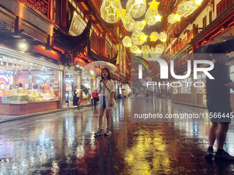 Tourists view the area amid heavy rain affected by a typhoon in Shanghai, China, on September 10, 2024. (