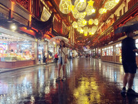 Tourists view the area amid heavy rain affected by a typhoon in Shanghai, China, on September 10, 2024. (