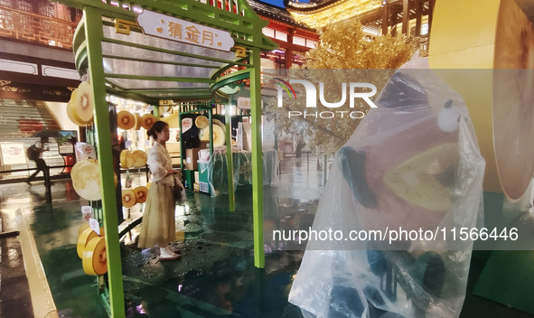 Tourists view the area amid heavy rain affected by a typhoon in Shanghai, China, on September 10, 2024. 