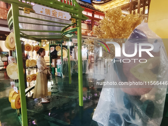 Tourists view the area amid heavy rain affected by a typhoon in Shanghai, China, on September 10, 2024. (