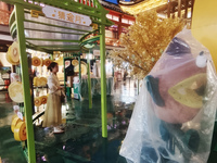 Tourists view the area amid heavy rain affected by a typhoon in Shanghai, China, on September 10, 2024. (