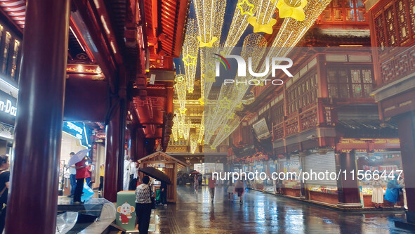 Tourists view the area amid heavy rain affected by a typhoon in Shanghai, China, on September 10, 2024. 