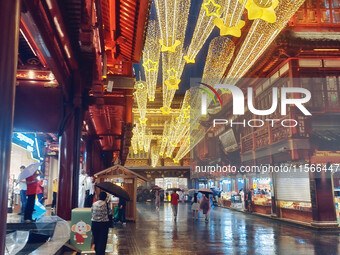 Tourists view the area amid heavy rain affected by a typhoon in Shanghai, China, on September 10, 2024. (