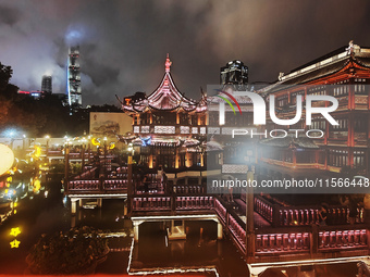 Tourists view the area amid heavy rain affected by a typhoon in Shanghai, China, on September 10, 2024. (