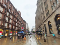 Tourists view the area amid heavy rain affected by a typhoon in Shanghai, China, on September 10, 2024. (