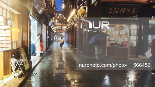 Tourists view the area amid heavy rain affected by a typhoon in Shanghai, China, on September 10, 2024. 