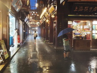 Tourists view the area amid heavy rain affected by a typhoon in Shanghai, China, on September 10, 2024. (