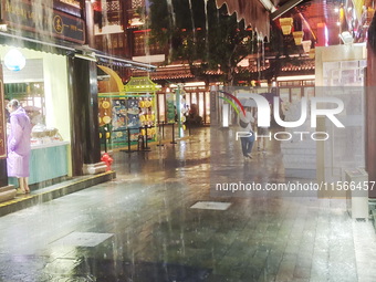 Tourists view the area amid heavy rain affected by a typhoon in Shanghai, China, on September 10, 2024. (