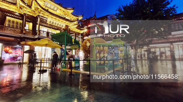 Tourists view the area amid heavy rain affected by a typhoon in Shanghai, China, on September 10, 2024. 