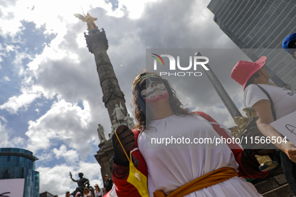 A woman participates in a protest at the Angel de la Independencia after the approval of the judicial reform to elect all judges by popular...