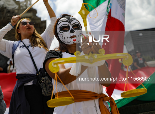 A woman participates in a protest at the Angel de la Independencia after the approval of the judicial reform to elect all judges by popular...