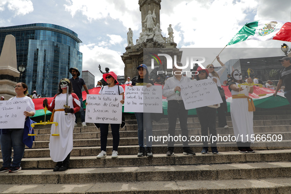 Judicial branch workers take part in a protest at the Angel de la Independencia after the approval of the judicial reform to elect all judge...