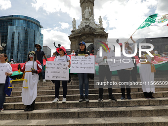 Judicial branch workers take part in a protest at the Angel de la Independencia after the approval of the judicial reform to elect all judge...