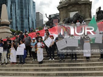 Judicial branch workers take part in a protest at the Angel de la Independencia after the approval of the judicial reform to elect all judge...