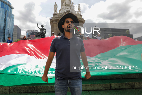 A person takes part in a protest at the Angel de la Independencia after the approval of the judicial reform to elect all judges by popular v...