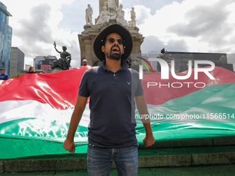 A person takes part in a protest at the Angel de la Independencia after the approval of the judicial reform to elect all judges by popular v...