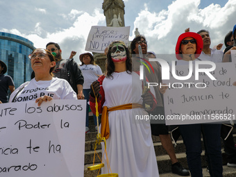 Judicial branch workers take part in a protest at the Angel de la Independencia after the approval of the judicial reform to elect all judge...