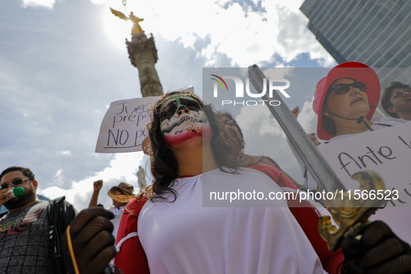 A woman participates in a protest at the Angel de la Independencia after the approval of the judicial reform to elect all judges by popular...