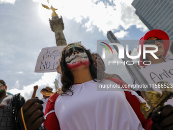 A woman participates in a protest at the Angel de la Independencia after the approval of the judicial reform to elect all judges by popular...