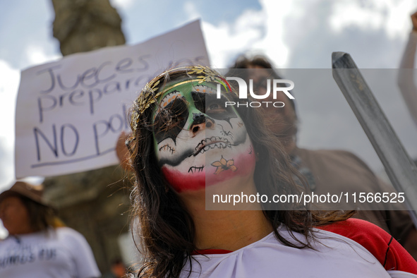 A woman participates in a protest at the Angel de la Independencia after the approval of the judicial reform to elect all judges by popular...