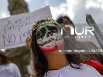 A woman participates in a protest at the Angel de la Independencia after the approval of the judicial reform to elect all judges by popular...