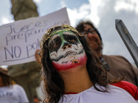 A woman participates in a protest at the Angel de la Independencia after the approval of the judicial reform to elect all judges by popular...