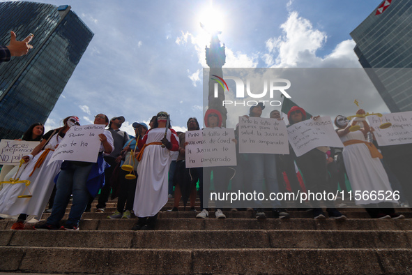 Judicial branch workers take part in a protest at the Angel de la Independencia after the approval of the judicial reform to elect all judge...