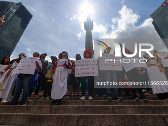 Judicial branch workers take part in a protest at the Angel de la Independencia after the approval of the judicial reform to elect all judge...