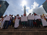 Judicial branch workers take part in a protest at the Angel de la Independencia after the approval of the judicial reform to elect all judge...