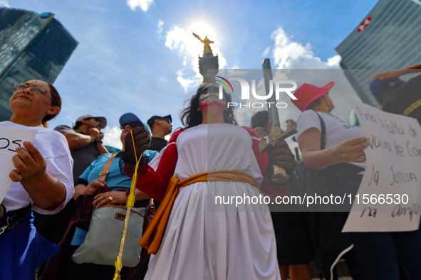 Judicial branch workers take part in a protest at the Angel de la Independencia after the approval of the judicial reform to elect all judge...