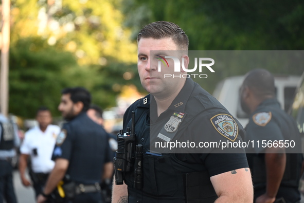 A police officer stands guard. The New York City Police Department investigates after a man is killed by a gunshot to the head in the East E...