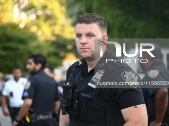 A police officer stands guard. The New York City Police Department investigates after a man is killed by a gunshot to the head in the East E...