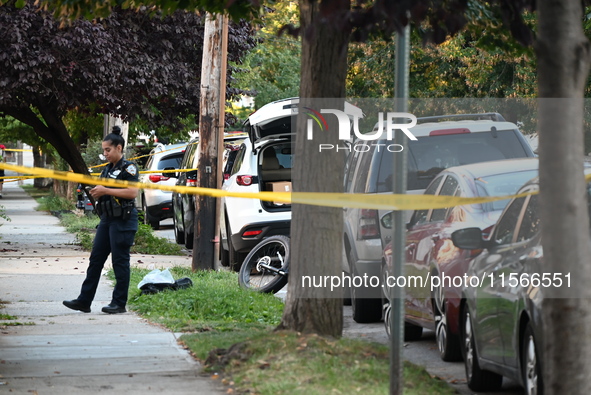 Police guard the crime scene. The New York City Police Department investigates after a man is killed by a gunshot to the head in the East El...