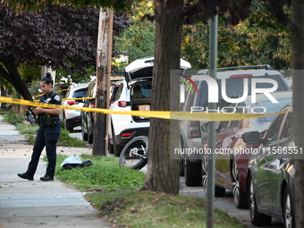 Police guard the crime scene. The New York City Police Department investigates after a man is killed by a gunshot to the head in the East El...