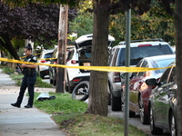 Police guard the crime scene. The New York City Police Department investigates after a man is killed by a gunshot to the head in the East El...