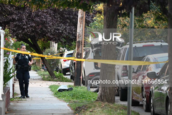 Police guard the crime scene. The New York City Police Department investigates after a man is killed by a gunshot to the head in the East El...