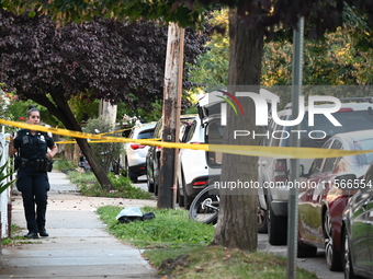 Police guard the crime scene. The New York City Police Department investigates after a man is killed by a gunshot to the head in the East El...